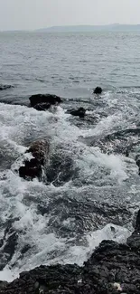 A rocky shoreline with crashing ocean waves.