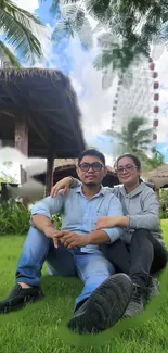 Couple sitting on grass in a scenic outdoor setting.