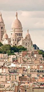 Montmartre and Paris skyline under a cloudy sky.