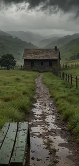 Rustic cottage in rainy mountain landscape.