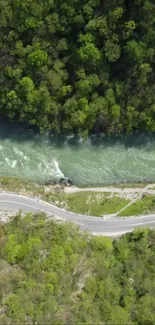 Aerial view of a scenic river flowing through a lush forest with winding road.