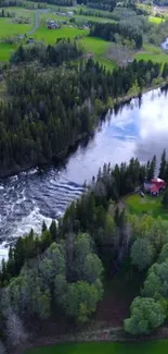 Aerial view of a river flowing through lush trees and greenery with a small cabin nearby.