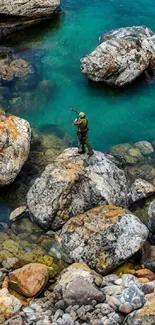 Person standing on rocks in turquoise river.