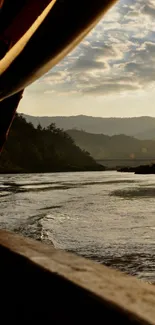 Calming sunset over a serene river with distant hills.