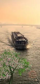 Serene river at sunset with boat and blossoming tree in foreground.