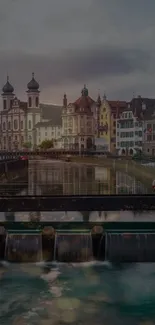 Riverside cityscape at dusk with historic buildings and reflections.