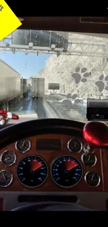 Dashboard view of scenic highway with rocks and road ahead.