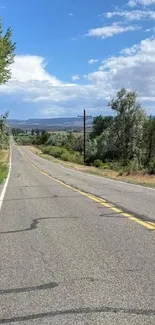 A scenic highway with trees and a blue sky on a sunny day.