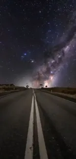 Dark road under a vibrant starry sky with galaxy view.