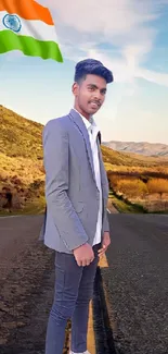 Man in suit on scenic road with flag under blue sky.