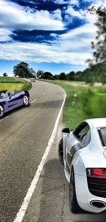 Sports cars on a scenic, curving countryside road.