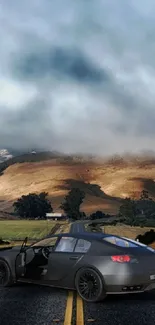 Sleek sports car on a scenic road with mountains and cloudy sky.