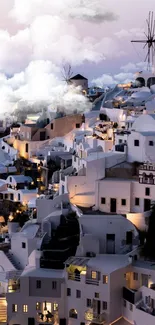 Santorini's iconic white buildings at night with windmills under a twilight sky.