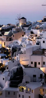 Evening view of Santorini's iconic white houses and windmills.