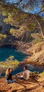 A serene coastal scene with azure waters, cliffs, and a person under trees.