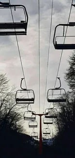 Cable cars in a misty gray sky.