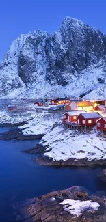 Snowy village at dusk with blue sky and mountains.