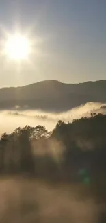 Scenic sunrise over misty mountains with golden sunlight.