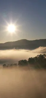 Sunrise over misty mountains with soft light rays and vibrant sky.