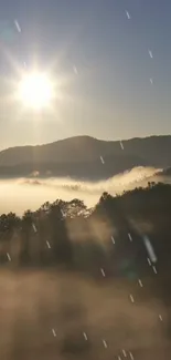 Scenic sunrise over misty mountains with glowing sunlight.