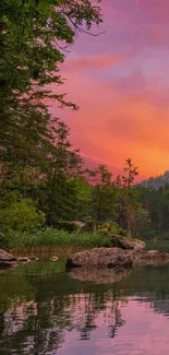 Serene lake with vibrant sunset sky and reflections.