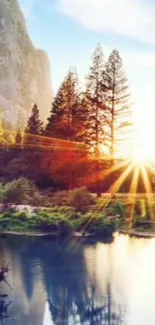 Sunset over a mountain landscape with trees and river.