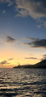 Peaceful sunset over the ocean with a stunning sky and serene water.