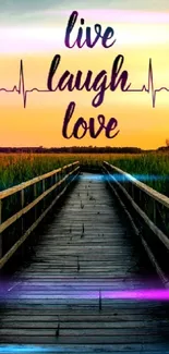 Serene sunset view from a wooden pathway with 'Live, Laugh, Love' text overlay.