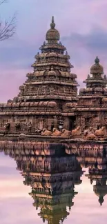 Scenic temple reflecting in calm waters with a pink sky.