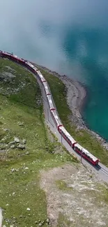 Train by an aqua blue lake amidst green hills.