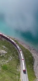 Scenic train passing by azure waters and lush green landscape.