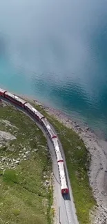 Aerial view of a train by a serene blue lake in a scenic landscape.