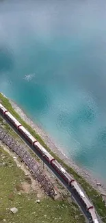 Long train by turquoise lake, scenic view.