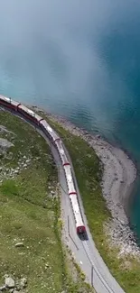 Aerial view of train by turquoise lake.