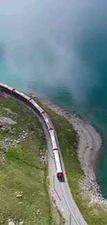 Train traveling along turquoise coast with green landscape.