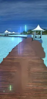 Wooden walkway leading to seaside gazebos over a clear tropical ocean.