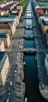 Aerial view of urban river flanked by symmetrical city architecture.