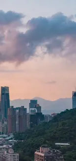 Serene sunset over city skyline with pink clouds.