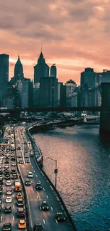 Cityscape at sunset with river and urban skyline.