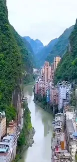 Scenic urban valley with river and mountains.