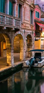 Venetian canal with a boat and historic buildings reflecting at dusk.