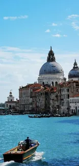 Venice canal with historic buildings and a boat under a blue sky.