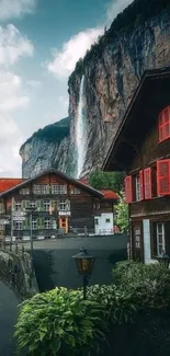 Scenic village with waterfall and rustic buildings amid lush greenery.