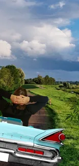 Vintage car driving down a scenic green country road under a blue sky.