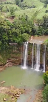 Aerial view of a waterfall in a lush green forest.