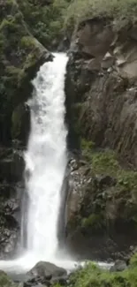 Waterfall cascading down cliffs amidst lush greenery.