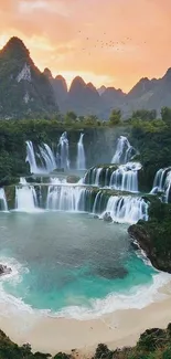 Beautiful waterfall and mountains at sunset with vibrant teal and orange hues.