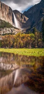 Breathtaking waterfall amidst mountain scenery with tranquil reflections.