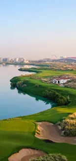 Serene view of a golf course by the water under a clear sky.