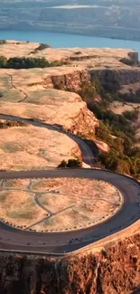 A beautiful winding road through golden cliffs with scenic views.